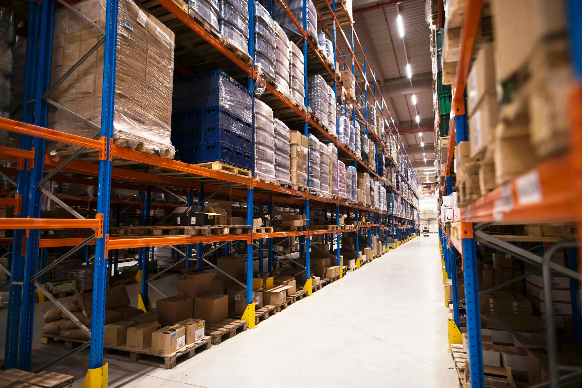 interior-large-distribution-warehouse-with-shelves-stacked-with-palettes-goods-ready-market-2